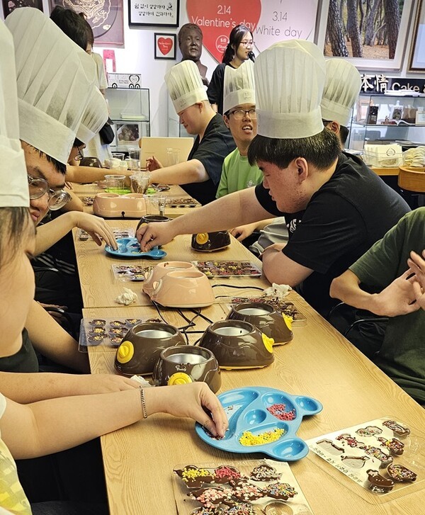 청주 혜원학교 학생들이 본정에서 초콜릿 체험 중 토핑 작업을 하고 있다. 공뉴스